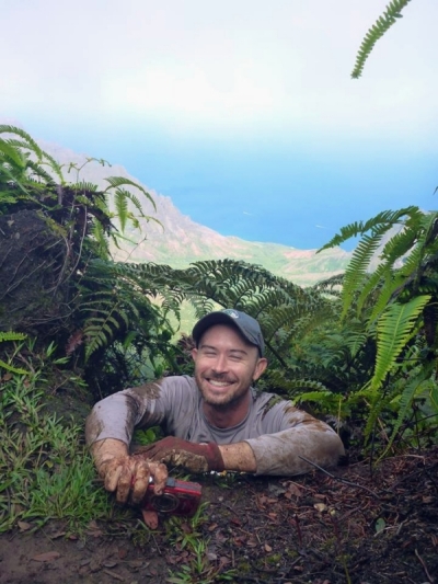 Matt checking a seabird burrow on Kauai